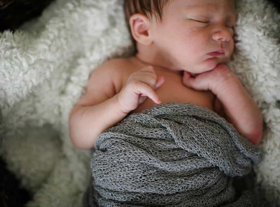 Baby liegt auf Felldecke